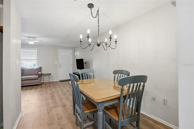 a view of a dining room with furniture and a chandelier