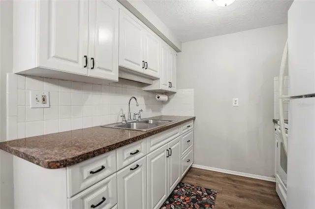 a kitchen with sink and mirror