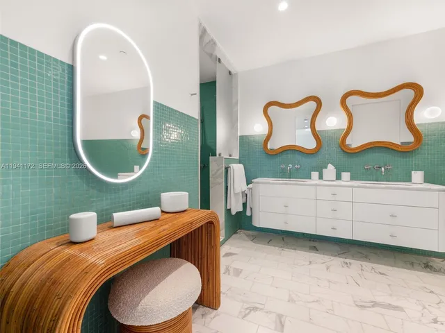 a bathroom with a toilet mirror vanity and sink