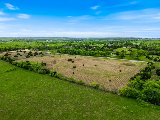 a view of a field with an ocean