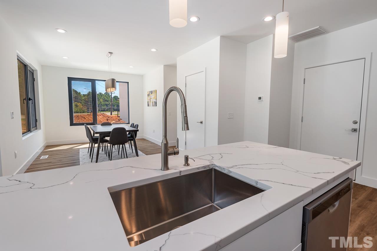 1115 Nova Street Durham, NC 27713 - Photo 23 of 56 a open kitchen with a table and chairs