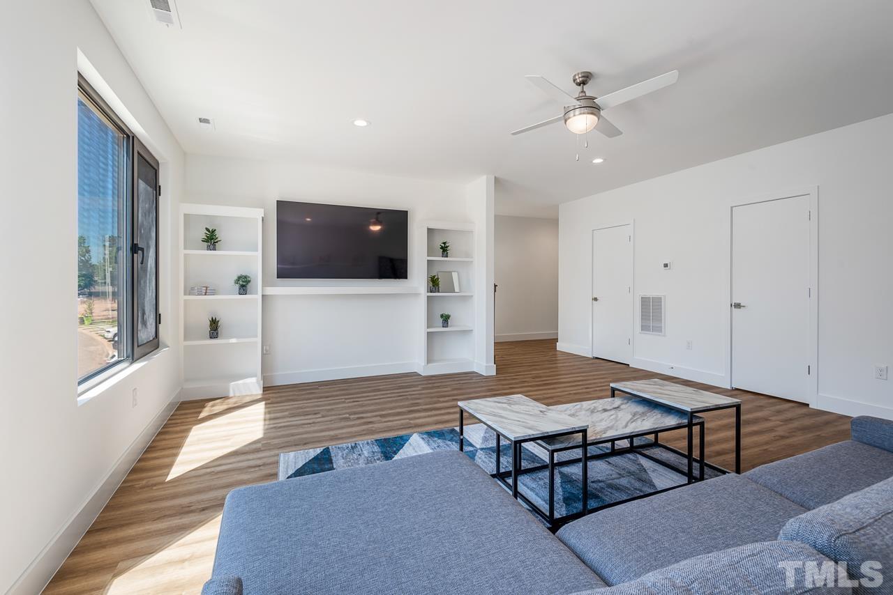1115 Nova Street Durham, NC 27713 - Photo 29 of 56 a living room with furniture and a flat screen tv
