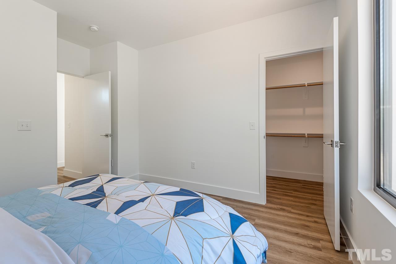 1115 Nova Street Durham, NC 27713 - Photo 51 of 56 a bedroom with a bed and a table