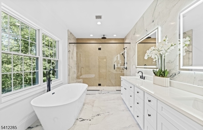 13 Penwood Road Livingston, NJ 07039 - Photo 10 of 18 a spacious bathroom with a double vanity sink a large mirror and a bathtub