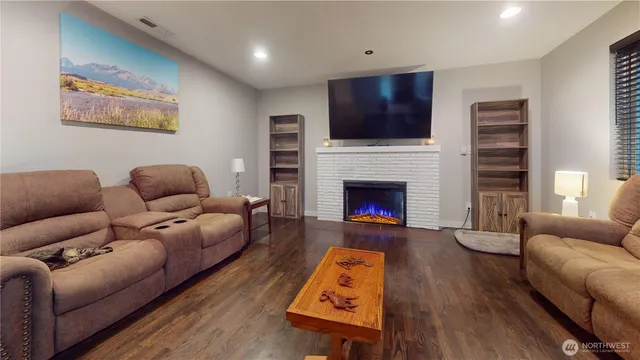 a living room with furniture fireplace and flat screen tv