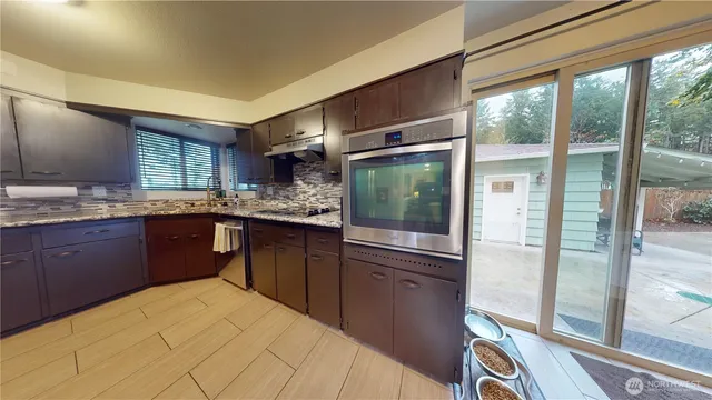 a kitchen with a refrigerator a sink and a cabinets