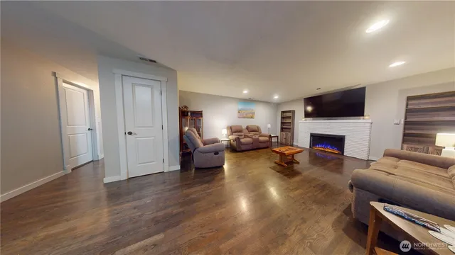 a living room with furniture a fireplace and a flat screen tv