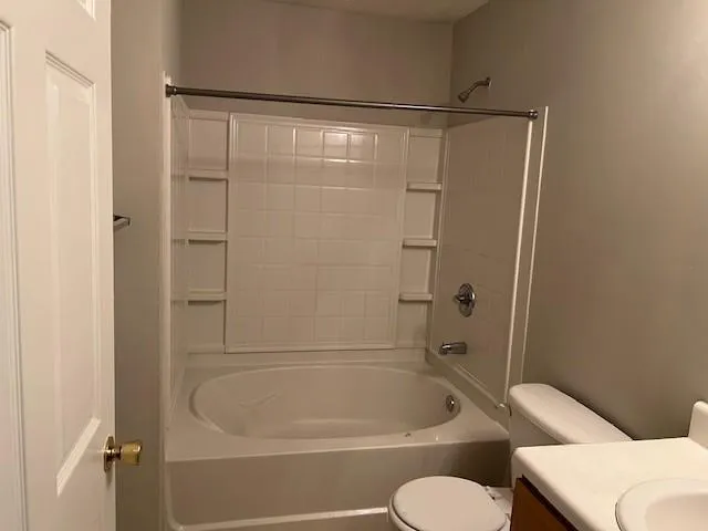 a bathroom with a shower and toilet