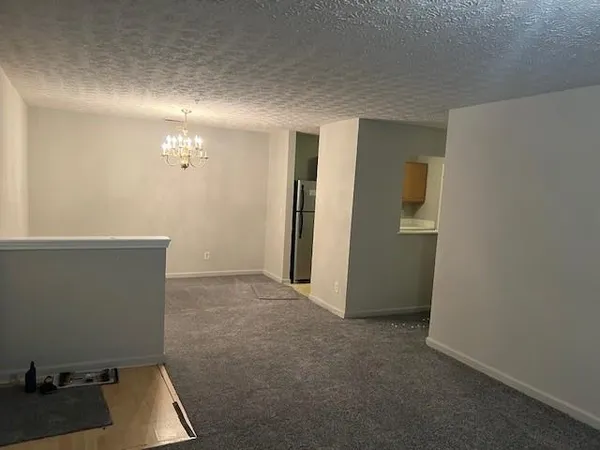 a view of hallway with cabinets and stairs