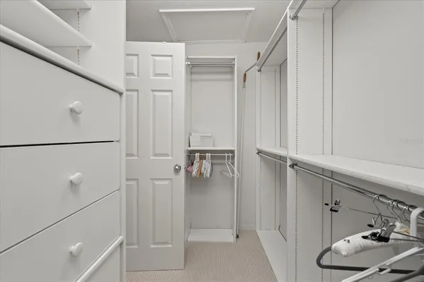 a bedroom with a large bed and a shower