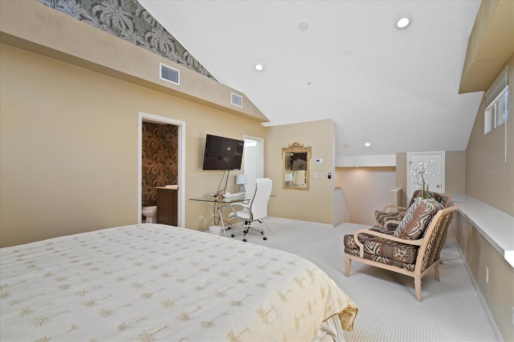 2254 Harbour Ct Drive Longboat Key, FL 34228 - Photo 15 of 57 a bedroom with a bed and a flat screen tv