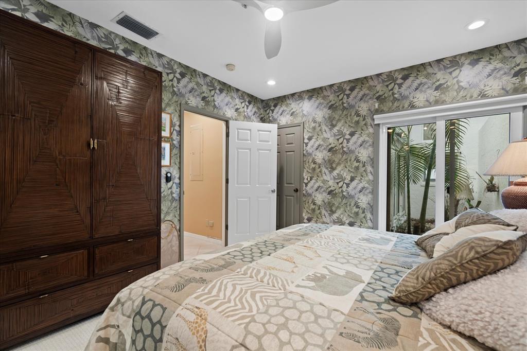 2254 Harbour Ct Drive Longboat Key, FL 34228 - Photo 19 of 57 a bedroom with a large bed and a shower