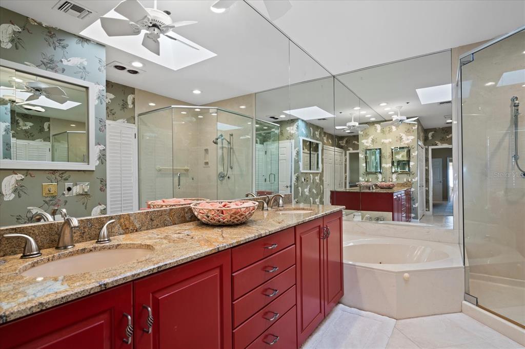 2254 Harbour Ct Drive Longboat Key, FL 34228 - Photo 23 of 57 a bathroom with a granite countertop tub sink shower and mirror