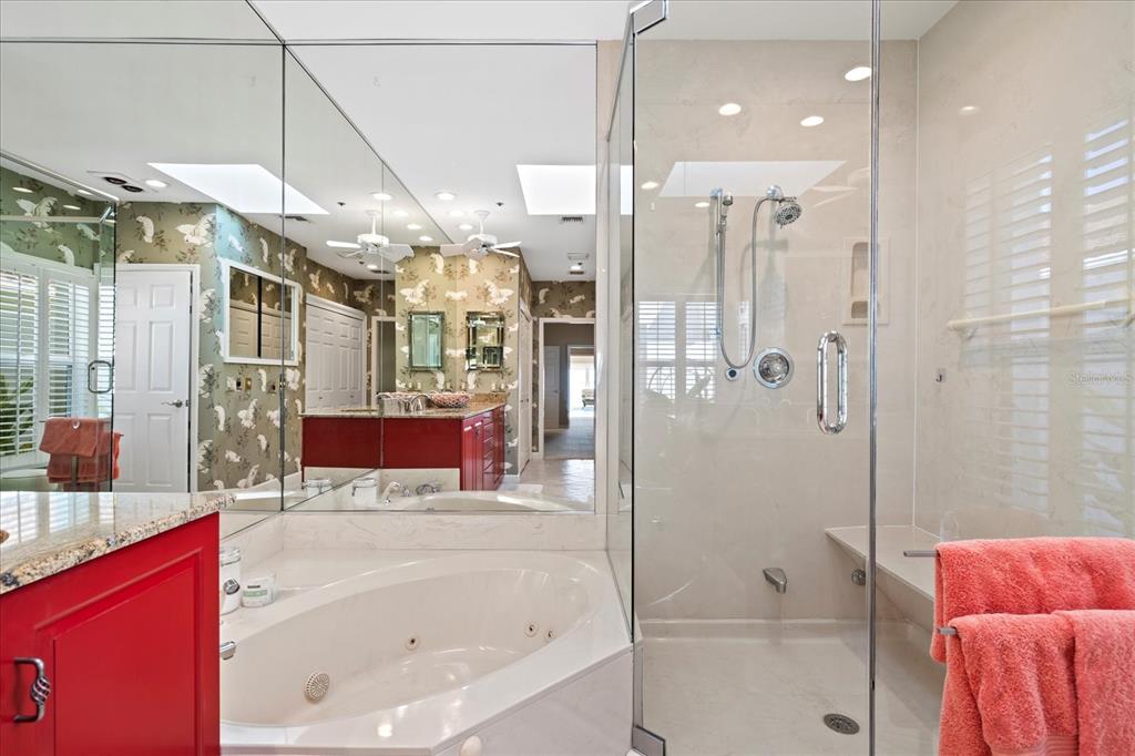 2254 Harbour Ct Drive Longboat Key, FL 34228 - Photo 24 of 57 a bathroom with a bathtub shower sink and mirror