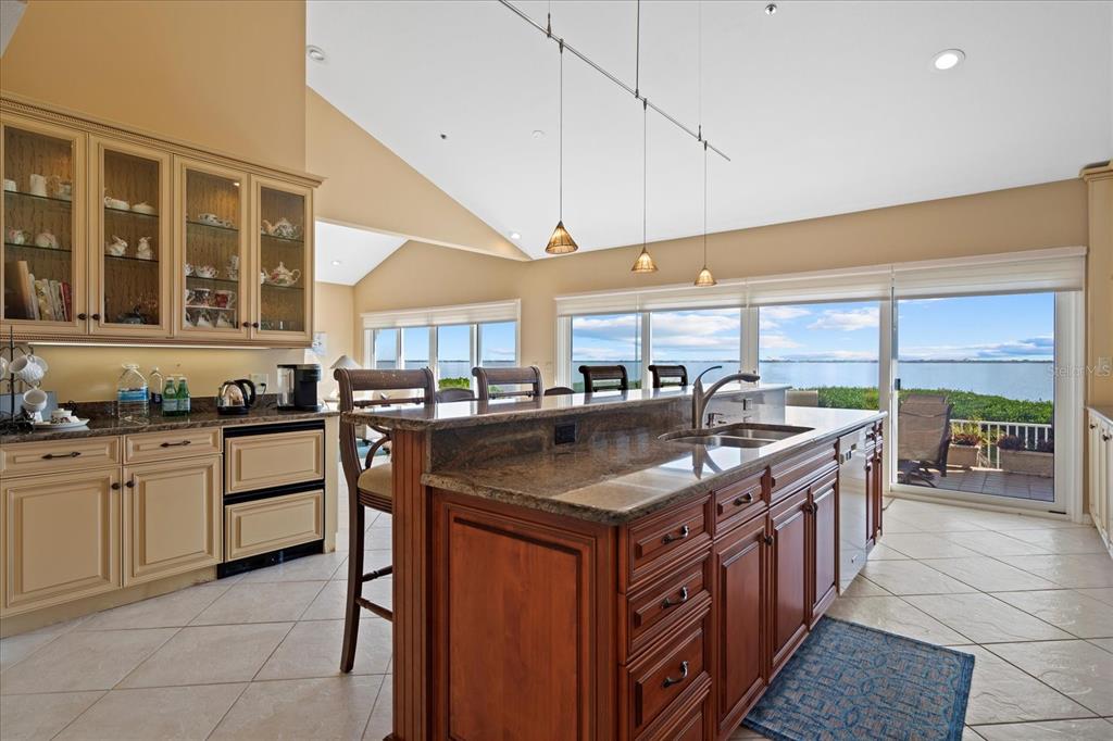 2254 Harbour Ct Drive Longboat Key, FL 34228 - Photo 39 of 57 a kitchen with stainless steel appliances granite countertop a sink and a large window