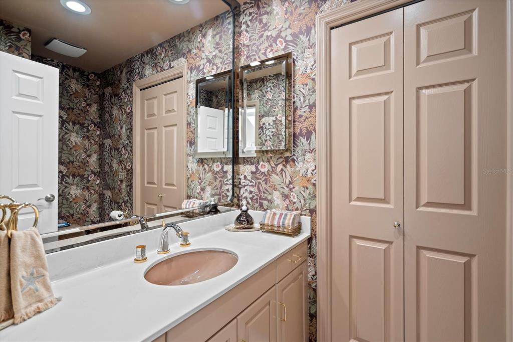 2254 Harbour Ct Drive Longboat Key, FL 34228 - Photo 45 of 57 a bathroom with a sink and a mirror