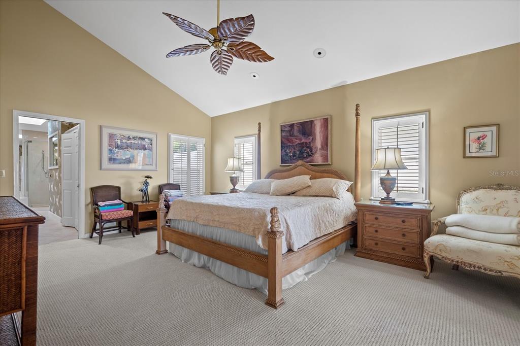 2254 Harbour Ct Drive Longboat Key, FL 34228 - Photo 48 of 57 a spacious bedroom with a bed couch and a window