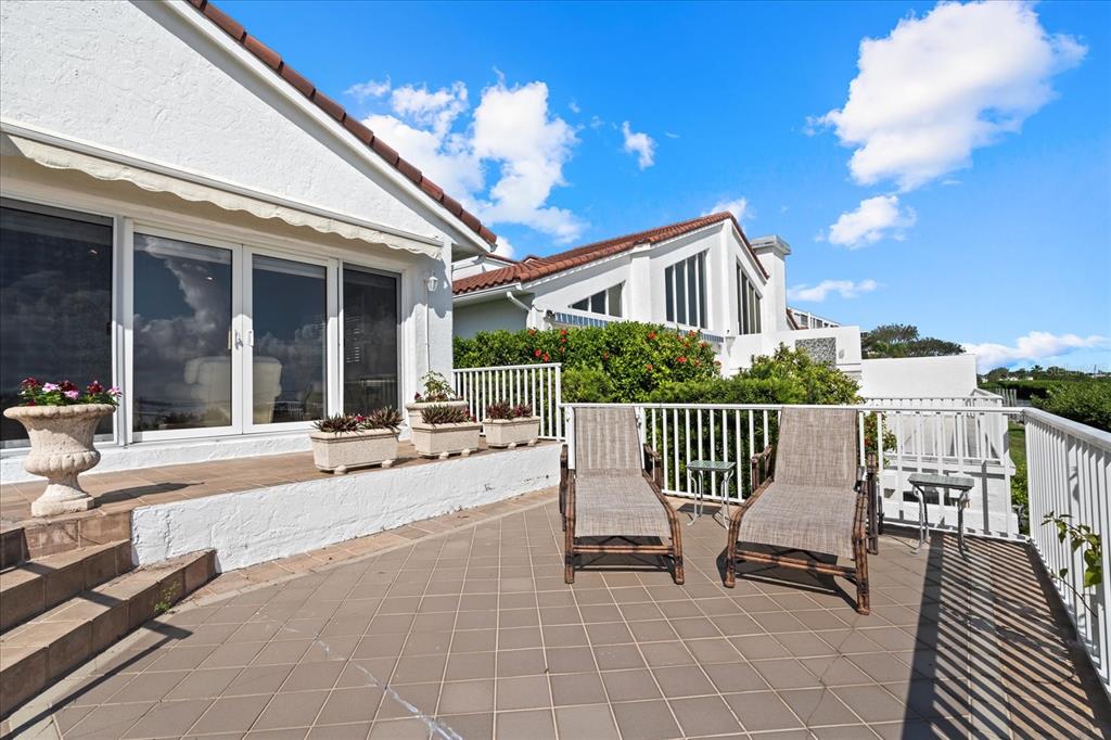 2254 Harbour Ct Drive Longboat Key, FL 34228 - Photo 55 of 57 a view of a chair and tables in the balcony