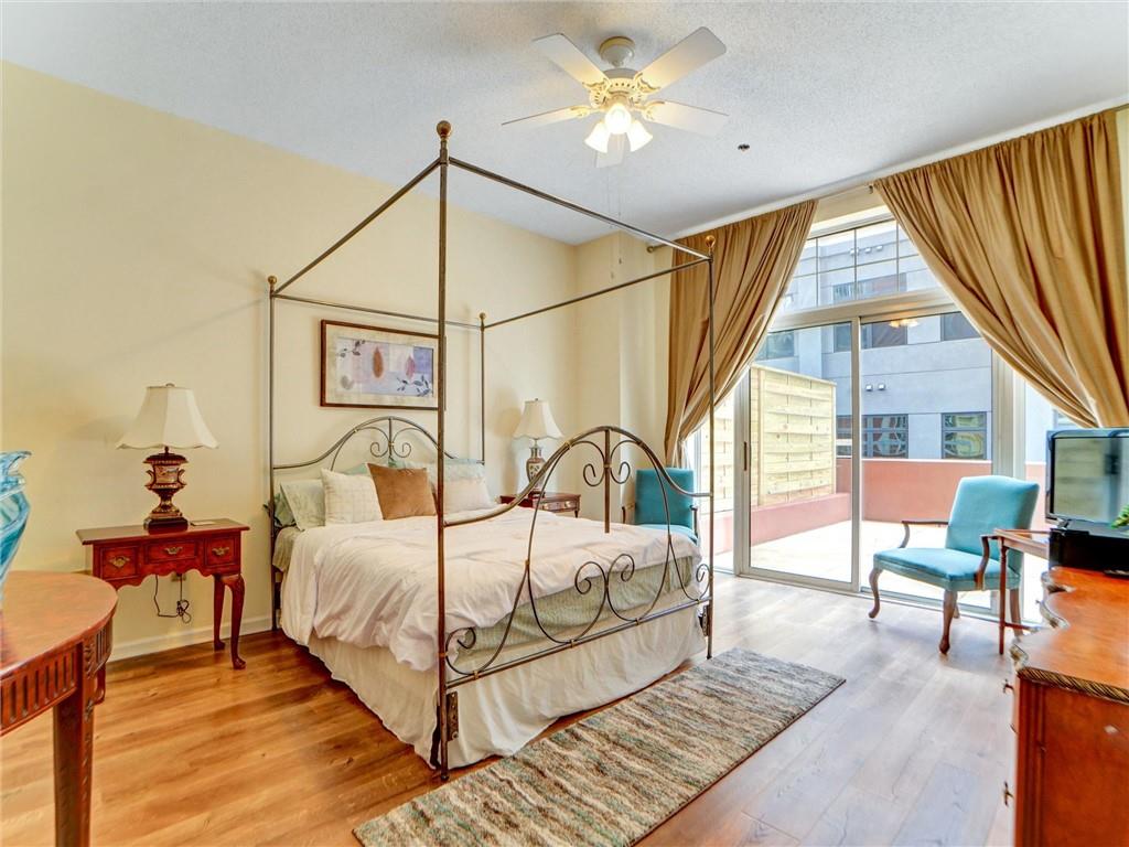 3435 Kingsboro Road Northeast, Unit 1601 Atlanta, GA 30326 - Photo 54 of 54 a bedroom with a bed and a chandelier