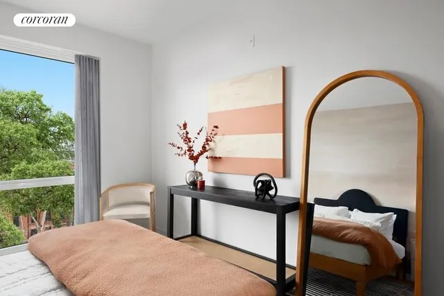 a bedroom with a bed and a potted plant