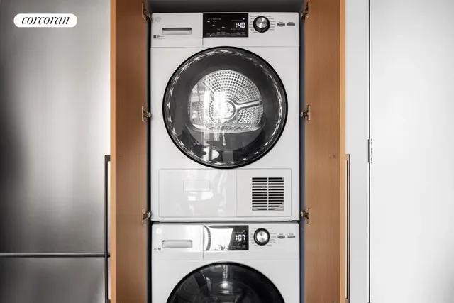 a roof deck with couches and potted plants