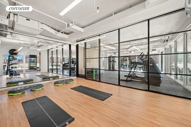 a living room with furniture a large window and a table