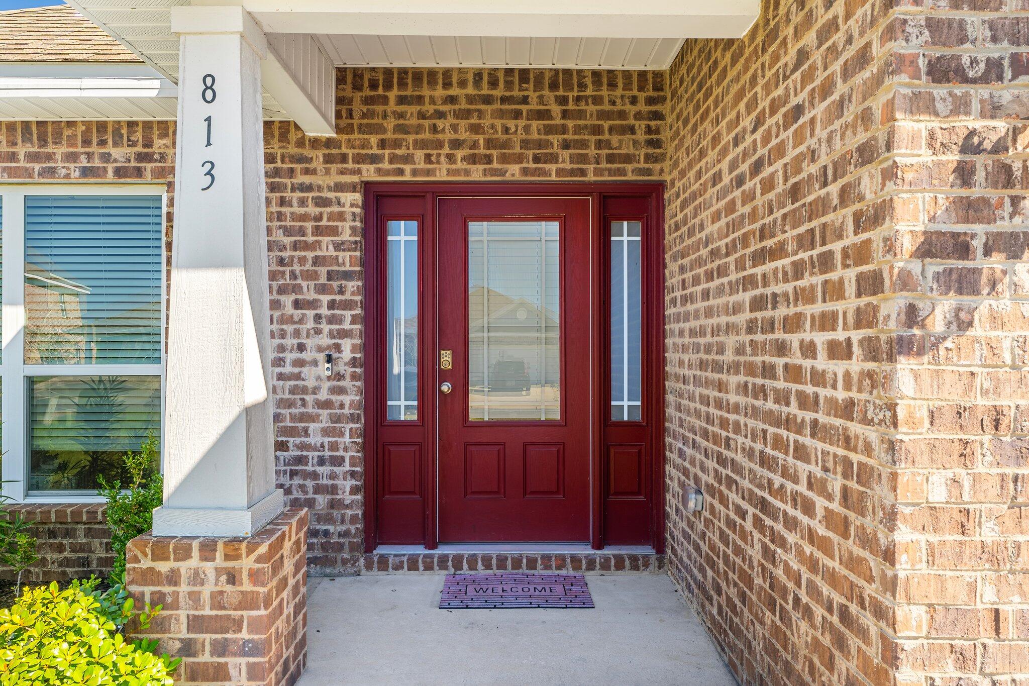 813 Cason Circle Panama City, FL 32405 - Photo 2 of 20 a front view of a building with a red door