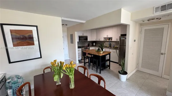 a dining room with furniture and a potted plant