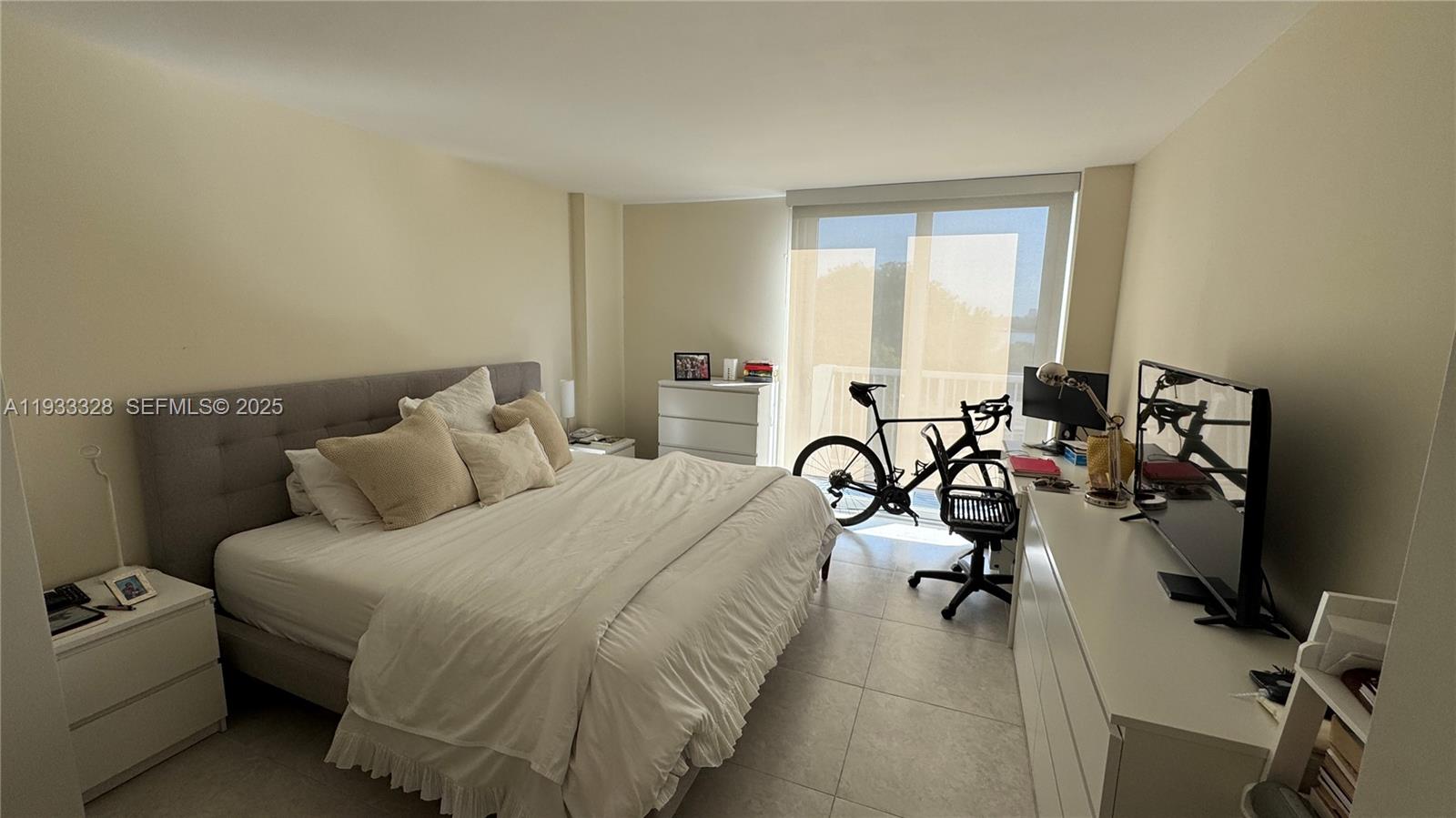 150 Southeast 25th Road, Unit 5L Miami, FL 33129 - Photo 6 of 9 a bedroom with bed a mirror and a window