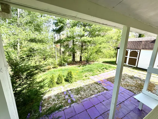 a view of a backyard with sitting area