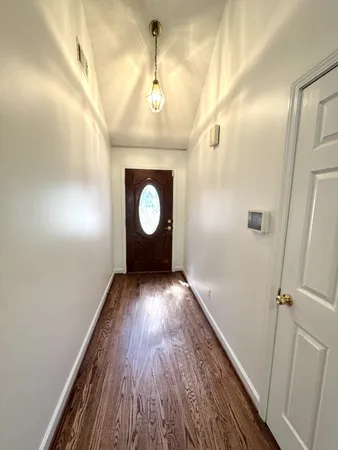 a view of a hallway with wooden floor