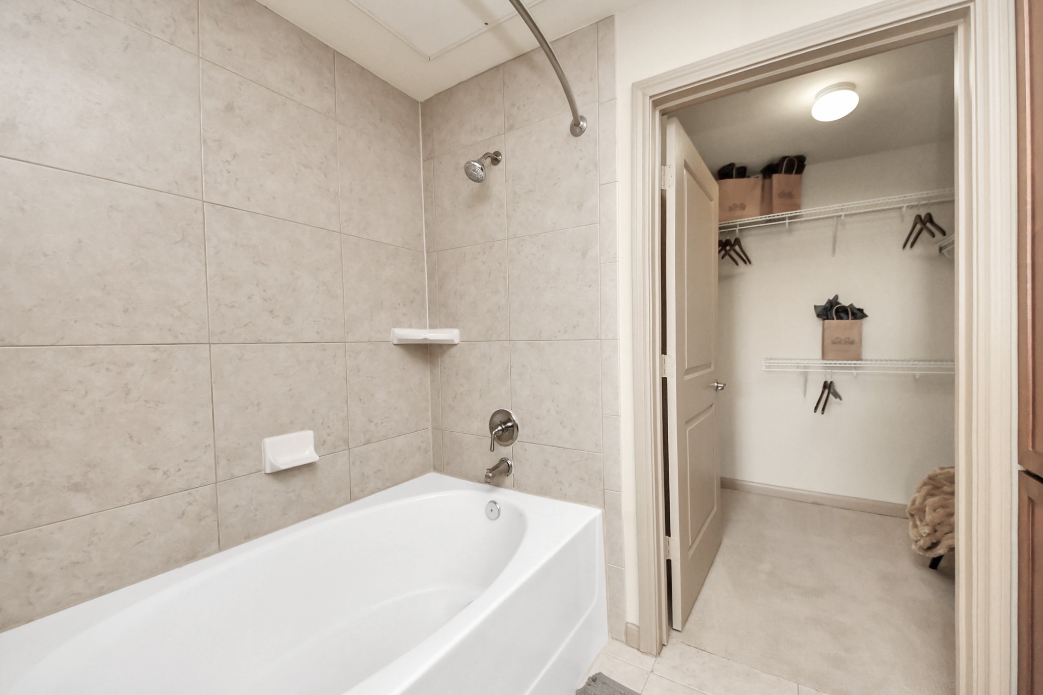 6363 San Felipe Street, Unit 314 Houston, TX 77057 - Photo 24 of 43 a bathroom with a tub and shower