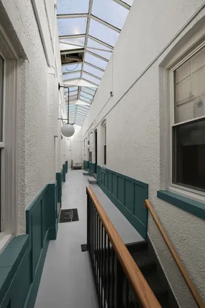 a kitchen with stainless steel appliances granite countertop a refrigerator a sink dishwasher a stove top oven a refrigerator with wooden floor