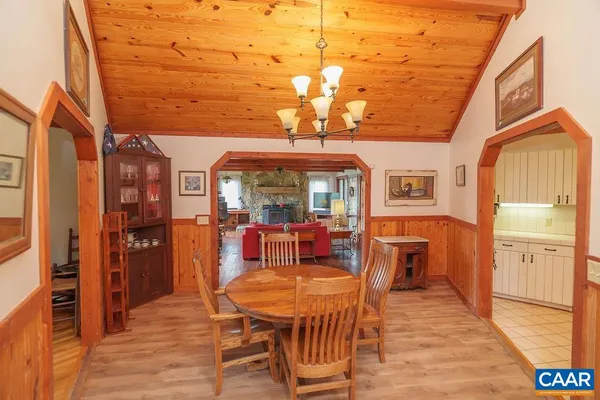 a living room with furniture floor to ceiling window and wooden floor