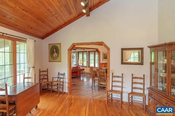 a view of staircase with white walls and a wooden floor