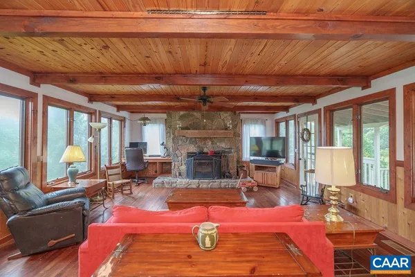 a living room with furniture a fireplace and a table