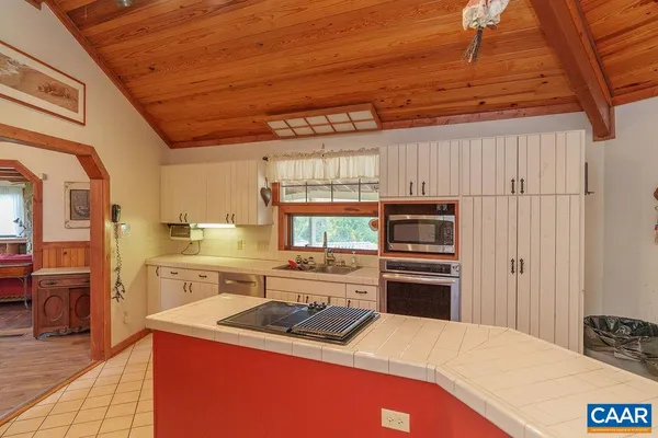 a kitchen with stainless steel appliances a stove sink and cabinets