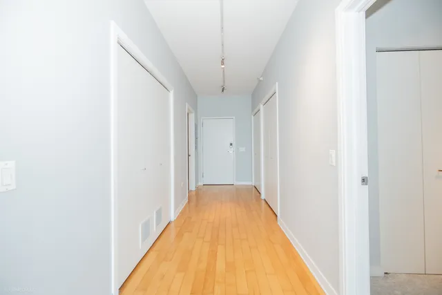 a kitchen with kitchen island and stainless steel appliances