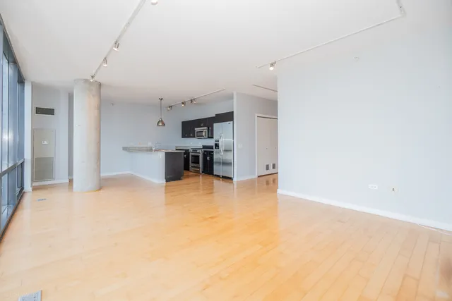 a kitchen with stainless steel appliances a refrigerator and a stove top oven