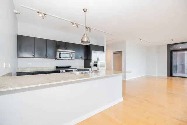 a view of a living room and kitchen