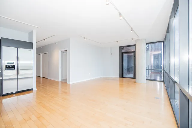 a kitchen with stainless steel appliances a sink and a large window