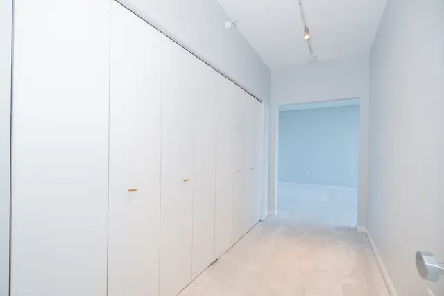 an empty room with sliding glass door and shower