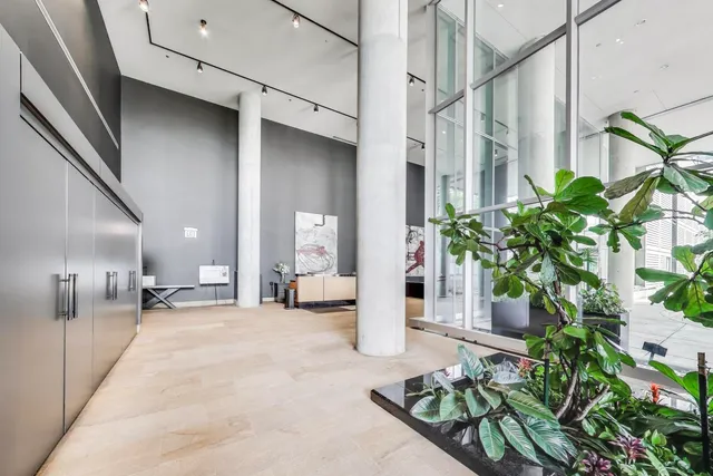 a lobby with furniture and potted plant