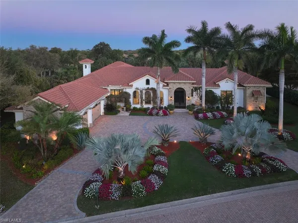 a front view of a house with a yard and outdoor seating