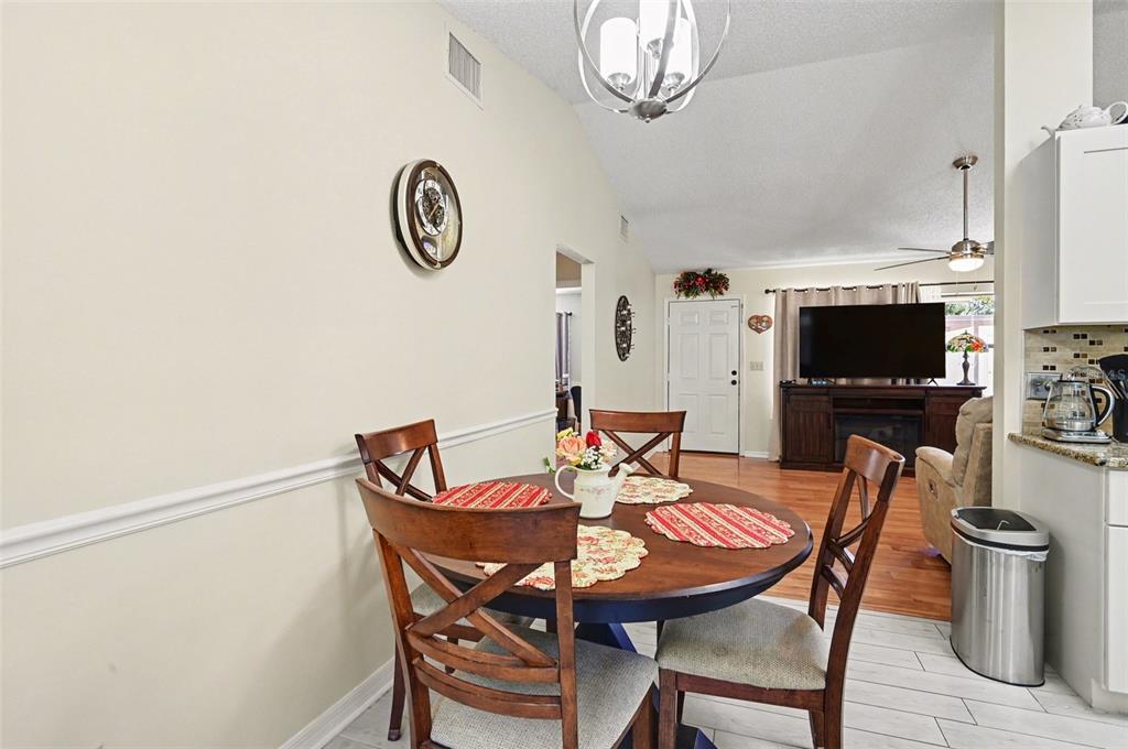 12435 Orangewood Circle Tavares, FL 32778 - Photo 11 of 30 a view of a dining room with furniture and a chandelier