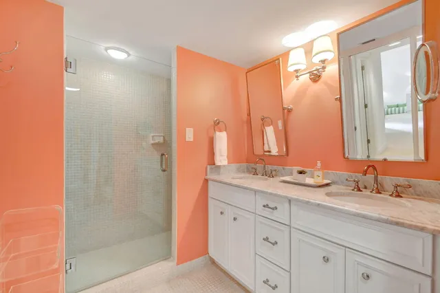 a bathroom with a granite countertop sink mirror and double