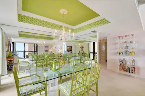 a view of a dining room with furniture and a chandelier