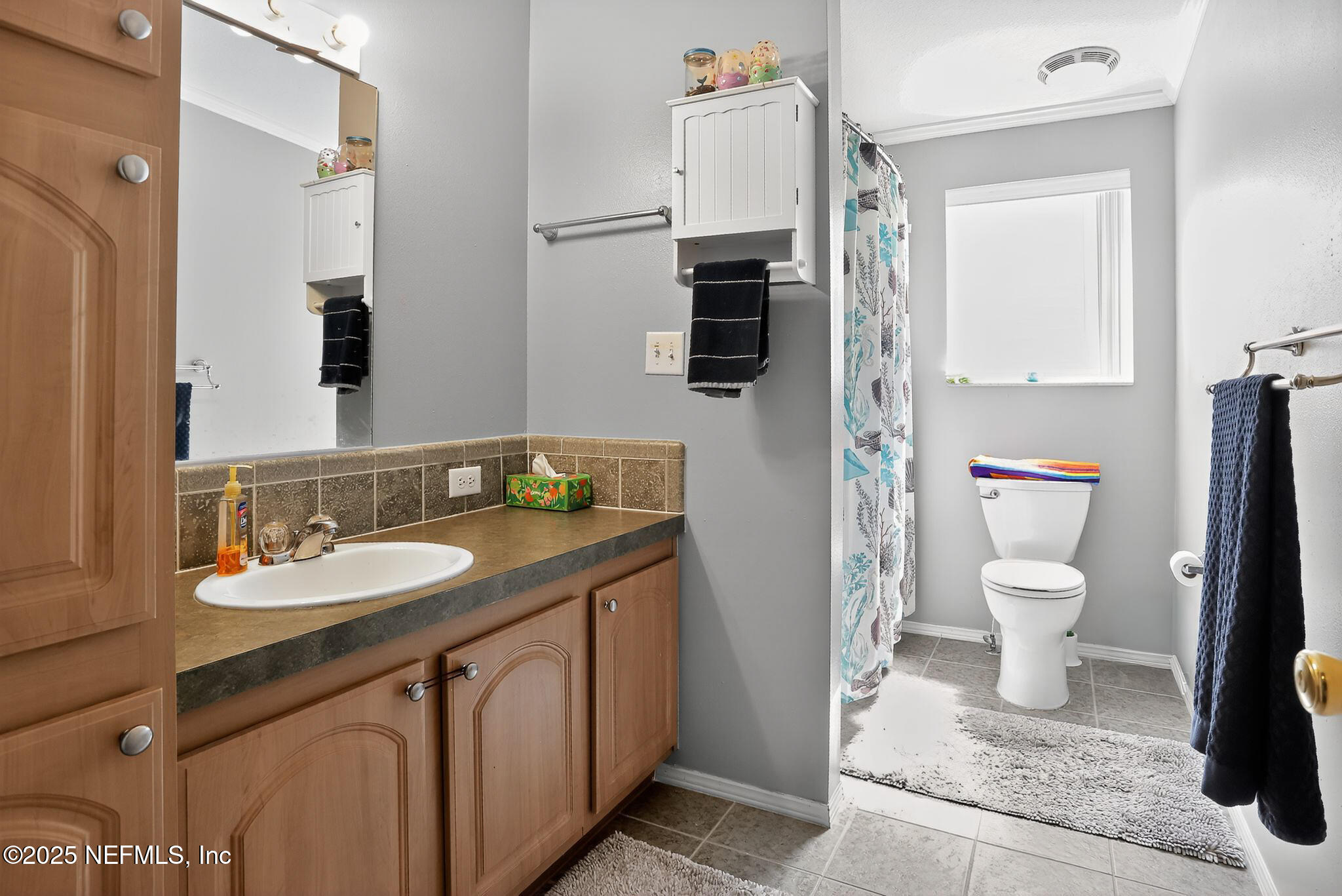 4824 Gadara Road Keystone Heights, FL 32656 - Photo 11 of 14 a bathroom with a granite countertop sink toilet and shower