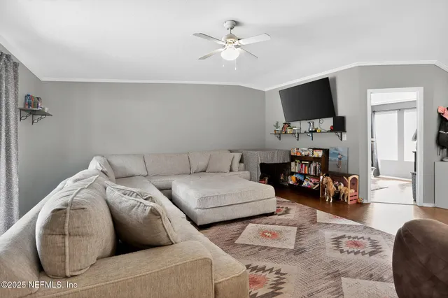 a living room with furniture and a flat screen tv