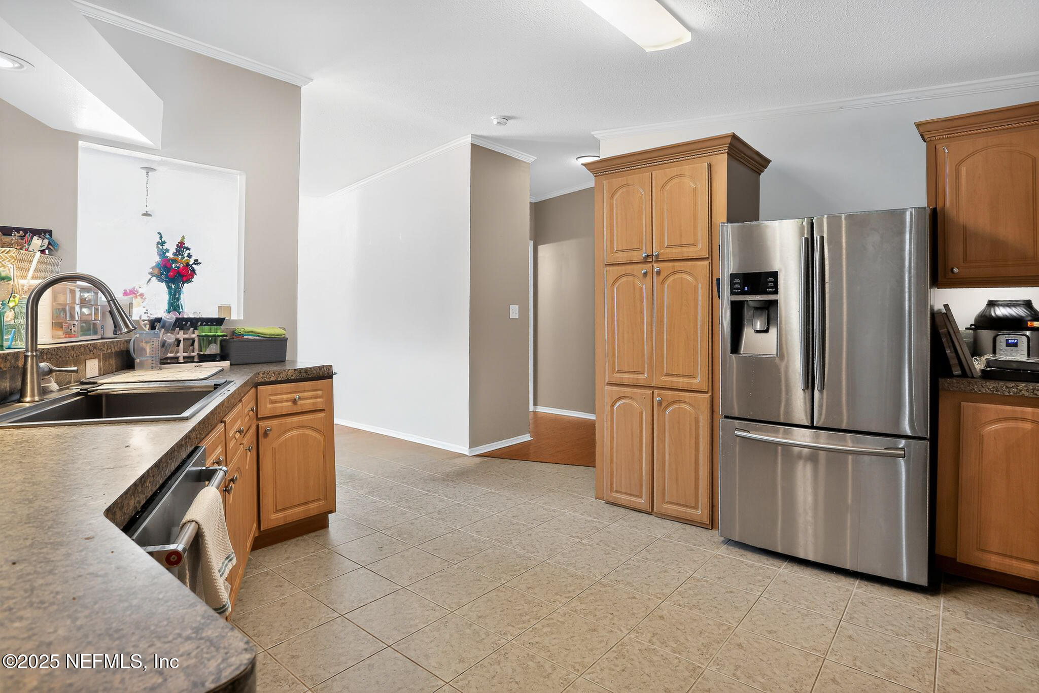4824 Gadara Road Keystone Heights, FL 32656 - Photo 6 of 14 a kitchen with stainless steel appliances granite countertop a refrigerator and a sink